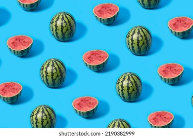Pattern of mini watermelons and slice watermelon halves on a blue background.