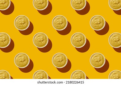Pattern of mustard bowls on yellow pastel background