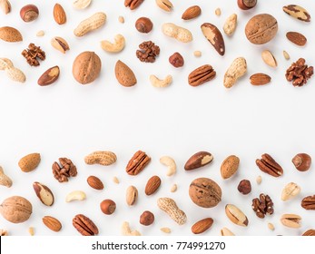 Pattern of nuts mix with copy space. Various nuts isolated on white. Pecan, macadamia, brazil nut, walnut, almonds, hazelnuts, pistachios, cashews, peanuts, pine nuts. Top view or flat-lay. Copy space