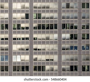 pattern of office facade with windows and shutter blinds as symbol for office work