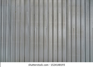 Pattern of old metal sheet roof texture. Rusty metal sheet texture. Aluminium Metal sheet roof for background or wallpaper. Silver white Corrugated metal texture surface.
