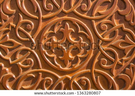 pattern on a wooden surface with deep relief and shadows. rough texture carving