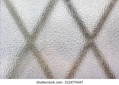 The pattern of the outer grate seen through frosted glass