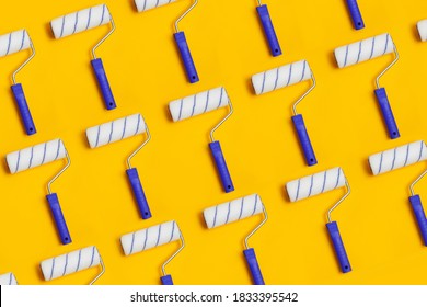 Pattern with paint roller with blue handle on yellow background. Clean roll for painting walls.