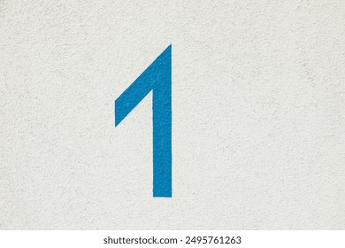 pattern of painted white house wall as harmonic background with blue house number 1