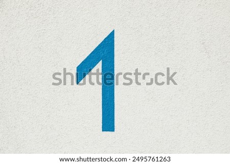 pattern of painted white house wall as harmonic background with blue house number 1
