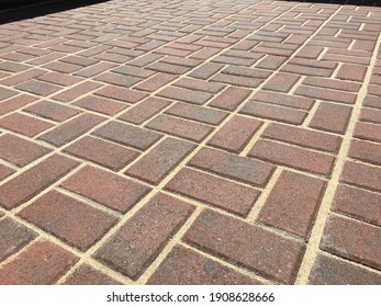 Pattern Of Red Pavers With Sand.