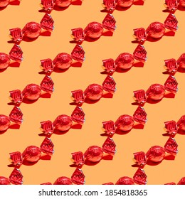 Pattern With Red Wrapped Candy On Orange Background.