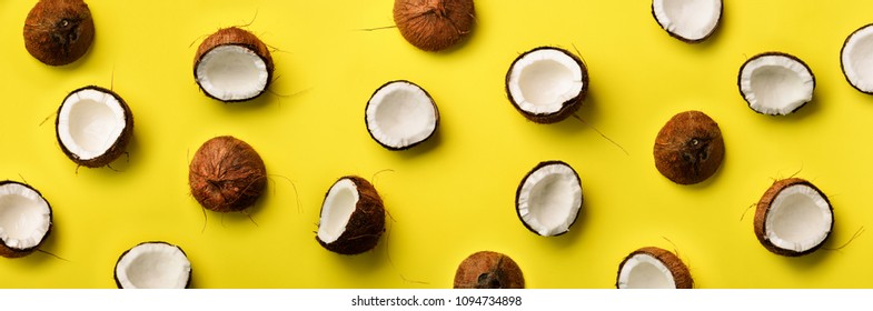 Pattern with ripe coconuts on yellow background. Top View. Copy Space. Pop art design, creative summer concept. Banner. Half of coconut in minimal flat lay style