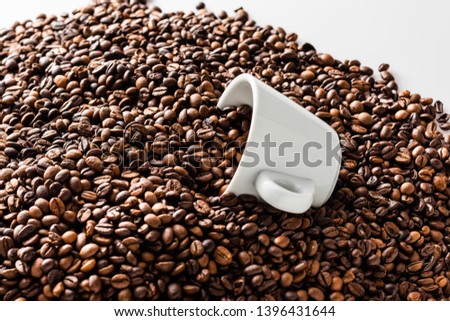 Pattern of roasted coffee beans with two white coffee cups