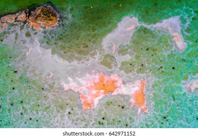 Pattern of salt. Aerial top down view on Chaka Salt Lake on the Tibetan Plateau showing white and orange salt structures surrounded by green water. Qinghai Province, China, May 2017