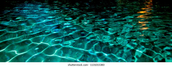 Pattern seen in the blue waters of this lake symbolizes the commonplace vast data sets, including big data. The zig zagged streak of golden reflection, akin to a plugged in deep learning AI algorithm. - Shutterstock ID 1131015383