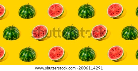 Pattern of sliced fresh watermelon on yellow background. Summer fruit, berry. Bold color. Trendy, Minimal shadows. Watermelon day concept -3 august.