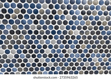Pattern of small round mosaic tiles in blue and grey shades. 
