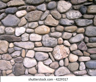 Pattern Of Soft Reds And Blues - River Rock - Mortared Together Into A Wall