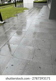 Pattern of square ventilation holes or concrete air vents on a grey building wall.