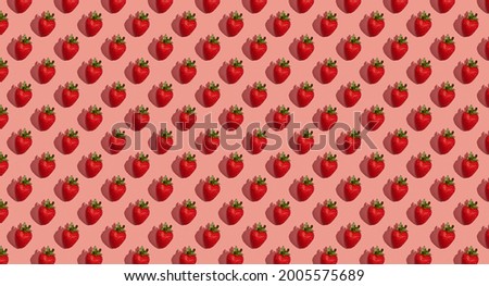 Pattern of strawberries on pastel pink background