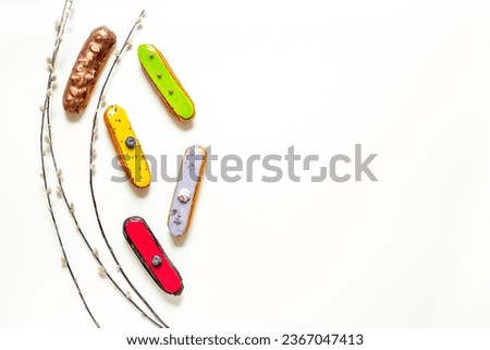 Pattern of various glased eclairs cakes. Sweet food background