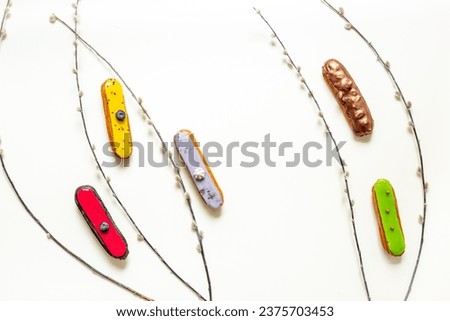 Pattern of various glased eclairs cakes. Sweet food background.