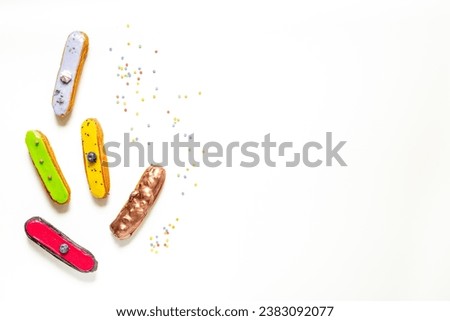Pattern of various glased eclairs cakes. Sweet food background.