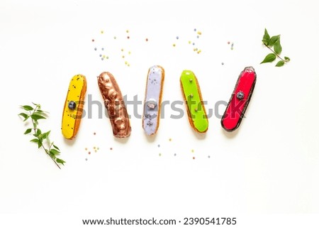 Pattern of various glased eclairs cakes. Sweet food background.