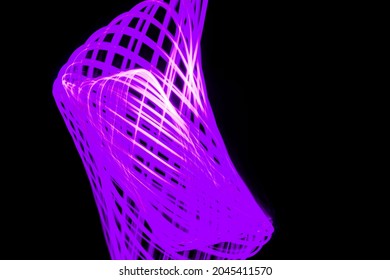 Pattern of violet lines on a black background painted with the light of a lantern.