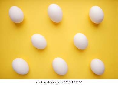 Pattern of white eggs on a yellow background. Easter template