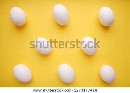 Pattern of white eggs on a yellow background. Easter template