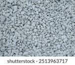 Pattern of white gravel with a uniform, clean texture. Сlose-up view of small, smooth gravel stones arranged in a seamless, repeating design. Ideal for backgrounds, surfaces, and abstract designs.