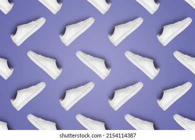 Pattern of white sneakers isolated on purple (Very Peri) background. Sportive pair of shoes for mockup. Fashionable stylish sports casual shoes. Modern and minimalist wallpaper of fashion lifestyle.