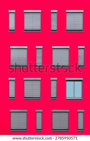 pattern of windows in different size with shutter at red wall