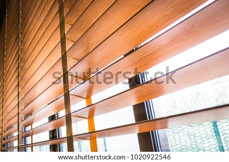 Pattern of the wooden shutters blinds (Windows blinds) with the light sunshine