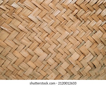 Pattern of woven seagrass basket. Abstract background - natural rattan or sea grass. Minimalistic simple beige rustic and natural pattern background