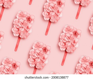 Pattern Wuth Pink Flowers Of Hydrangea As Ice Cream On Stick Or Popsicle On Pastel Pink Background. Creative Concept Of Summer Food In Minimal Style. Top View, Flat Lay.