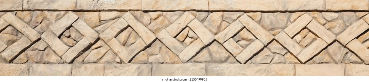 pattern yellow color of ancient style design decorative uneven cracked real stone wall surface with cement. Old sacred tomb facade with sunlight in daytime