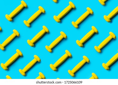 Pattern Of Yellow Dumbbells On A Blue Background