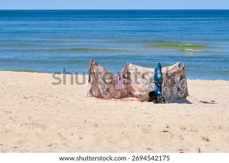 Patterned beach windscreen on sandy Baltic Sea beach