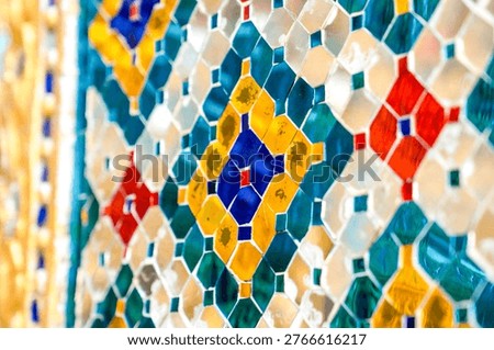 Patterned walls, frames, and roof edges create a rich study of Thai temple design. Repeated motifs and colors fill each close architectural view.