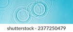 Patterns from Circles from drops on clear water Transparent blue water surface with ripples. Cosmetic moisturizing essence Banner