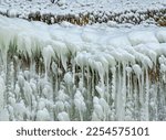Patterns and ice deatil is highlighted in this close-uo on the back of a ice fall ice stack, St Louis Canyon, Starved Rock State Park, LaSalle County, Illinois