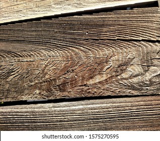 Patterns In A Plank Of Wood In An Old Outdoor Redwood Fence 