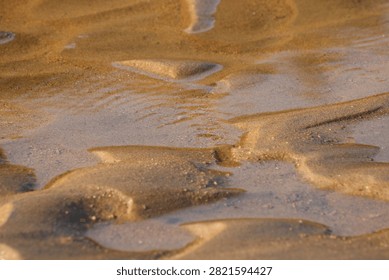  Patterns in sand created by tidal. 