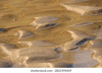  Patterns in sand created by tidal. 