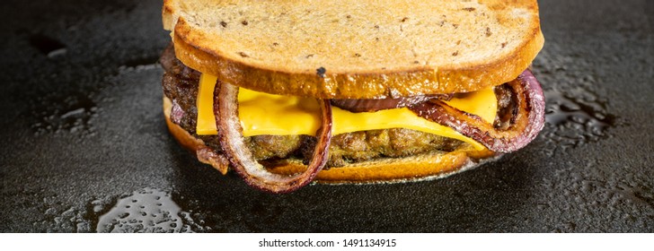 Patty Melt Burger Cooking On The Flat Top Griddle.