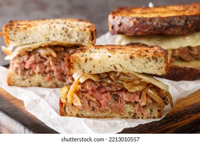 Patty Melt Burger Sandwich With Cheese And Onions Closeup On The Wooden Board On The Table. Horizontal
