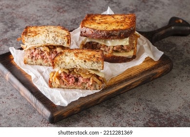 Patty Melt Is A Sandwich Consisting Of A Ground Beef Patty With Melted Cheese And Topped With Caramelized Onions Between Two Slices Of Griddled Bread Closeup On The Wooden Board
