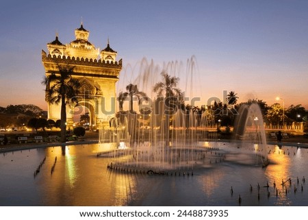 Patuxai Victory Monument (Vientiane Arc de Triomphe) and fountain floodlit at dusk, Vientiane, Laos, Indochina, Southeast Asia, Asia