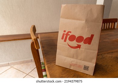 São Paulo, Brazil. August 20, 2022. Ifood Delivery Bag On Wooden Table,