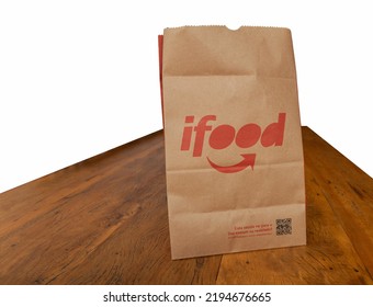 São Paulo, Brazil. August 20, 2022. Ifood Delivery Bag On Wooden Table, White Background.