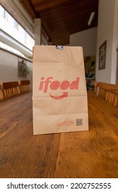 São Paulo, Brazil. August 20, 2022. Ifood Delivery Bag On Wooden Table.